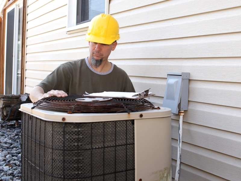 professional hvac technicians check leaks in AC units