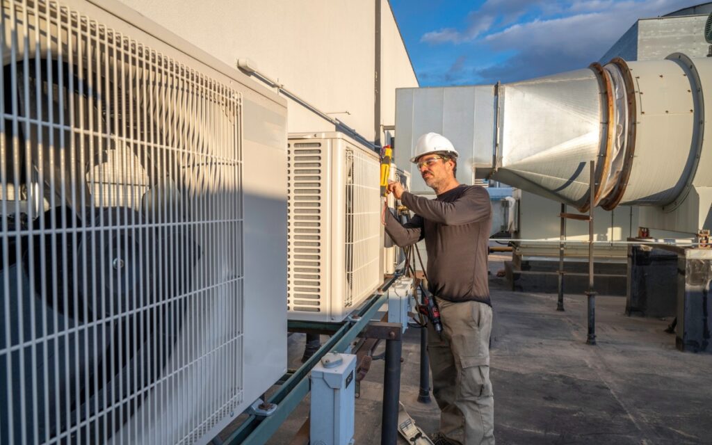 HVAC technician servicing commercial air conditioner