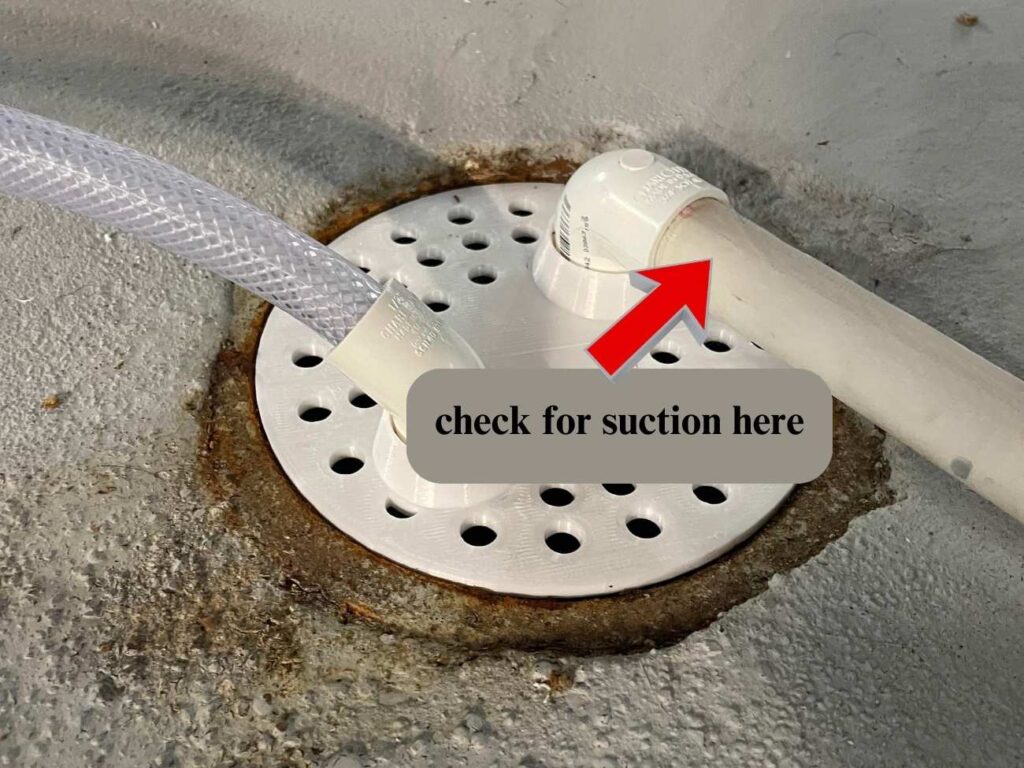 check for suction at the end of the drain line